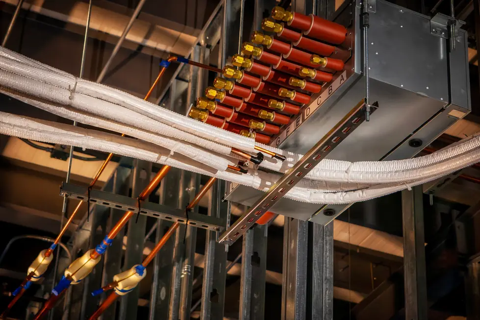 Insulated refrigerant lines and a branch box installed overhead in a commercial ceiling
